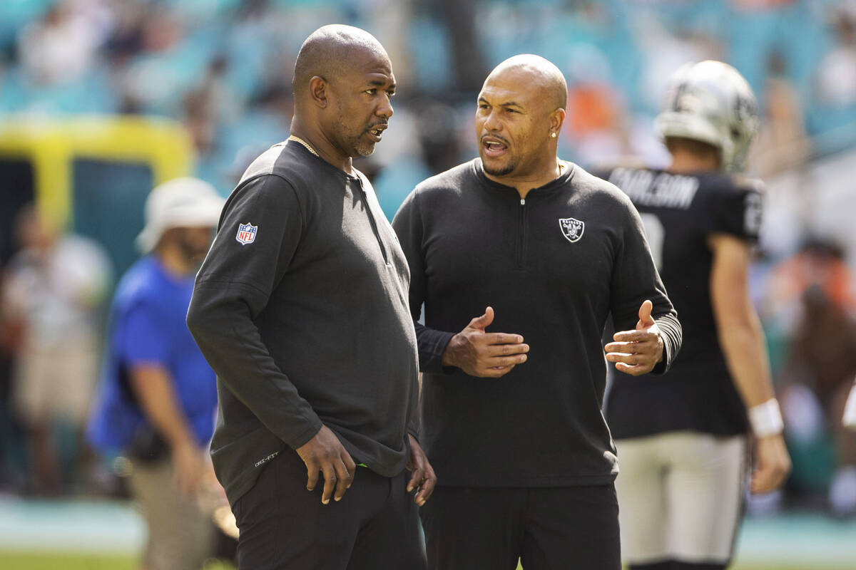 Raiders defensive coordinator Patrick Graham, left, and interim head coach Antonio Pierce inte ...