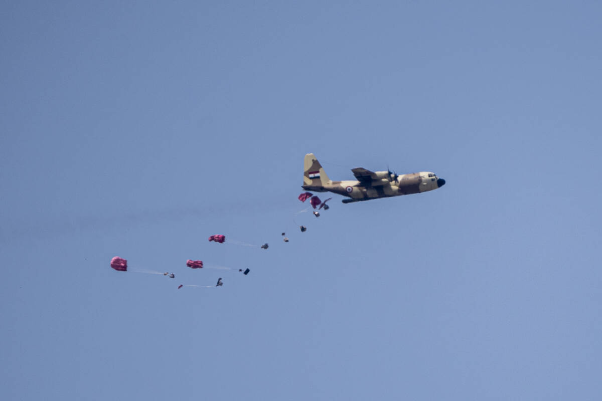 An aircraft airdrops humanitarian aid over the northern Gaza Strip, as seen from southern Israe ...