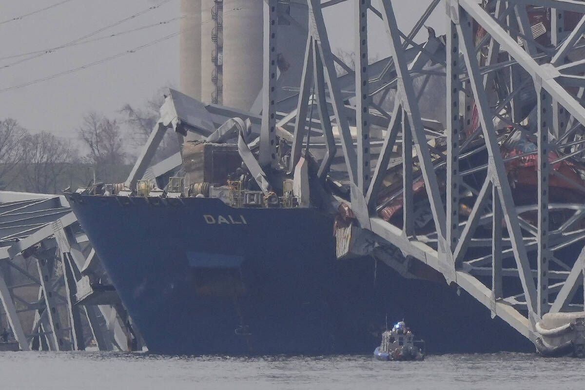 A container rests against wreckage of the Francis Scott Key Bridge on Tuesday, March 26, 2024, ...