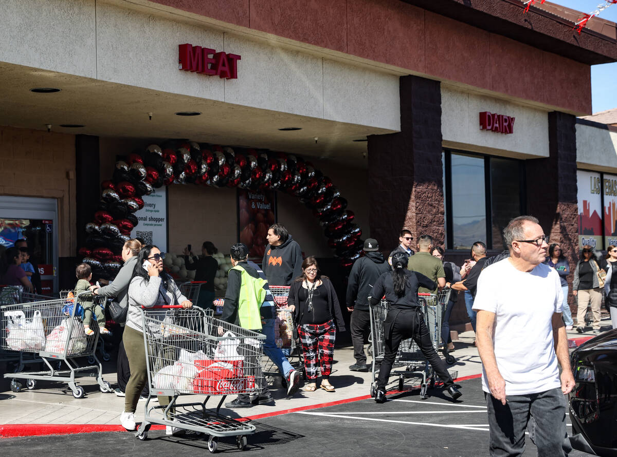 Customers exit and enter Superior Grocers at the grand opening in East Las Vegas, Wednesday, Ma ...