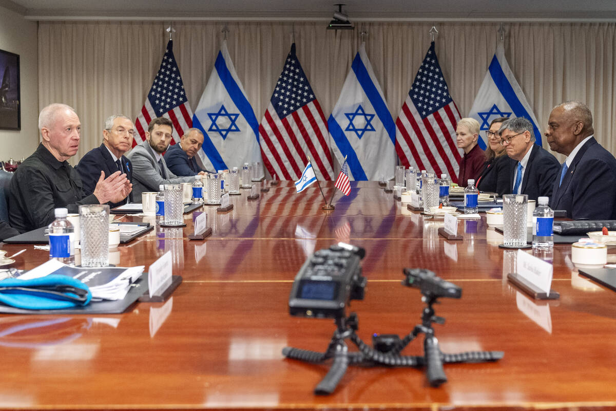 Israeli Defense Minister Yoav Gallant, at far left, speaks while meeting with Defense Secretary ...