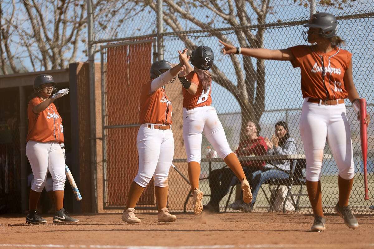 Legacy celebrates after scoring multiple runs on Clark during a high school softball game at Le ...