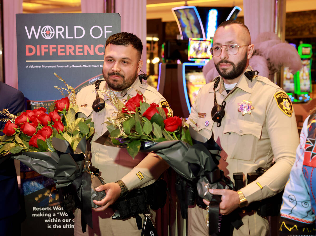 For 1A Thursday. DON'T USE in B section. Las Vegas police officers Humberto Zarate, left, and O ...
