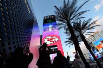 Football fans photograph a Super Bowl marquee at Aria, Saturday, Feb. 10, 2024, on Strip. (Ell ...