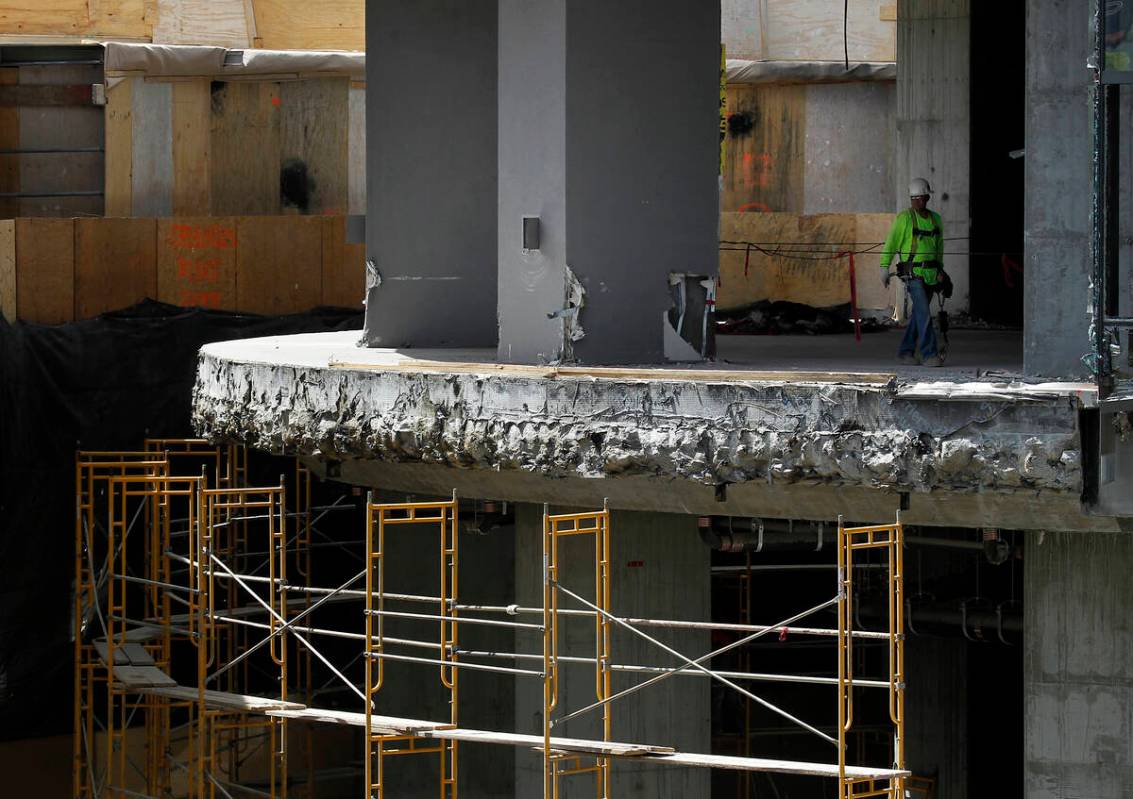 A worker is seen during the demolition of the Harmon Hotel at City Center in Las Vegas on Frida ...