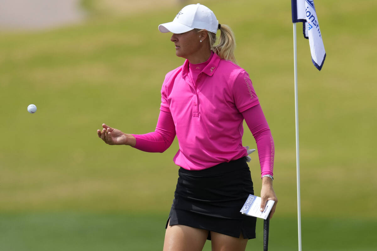 Anna Nordqvist throws her ball to her caddie on the third green during the first round of LPGA ...