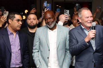 NFL legend Emmitt Smith, center, takes in the atmosphere during an opening night party for his ...