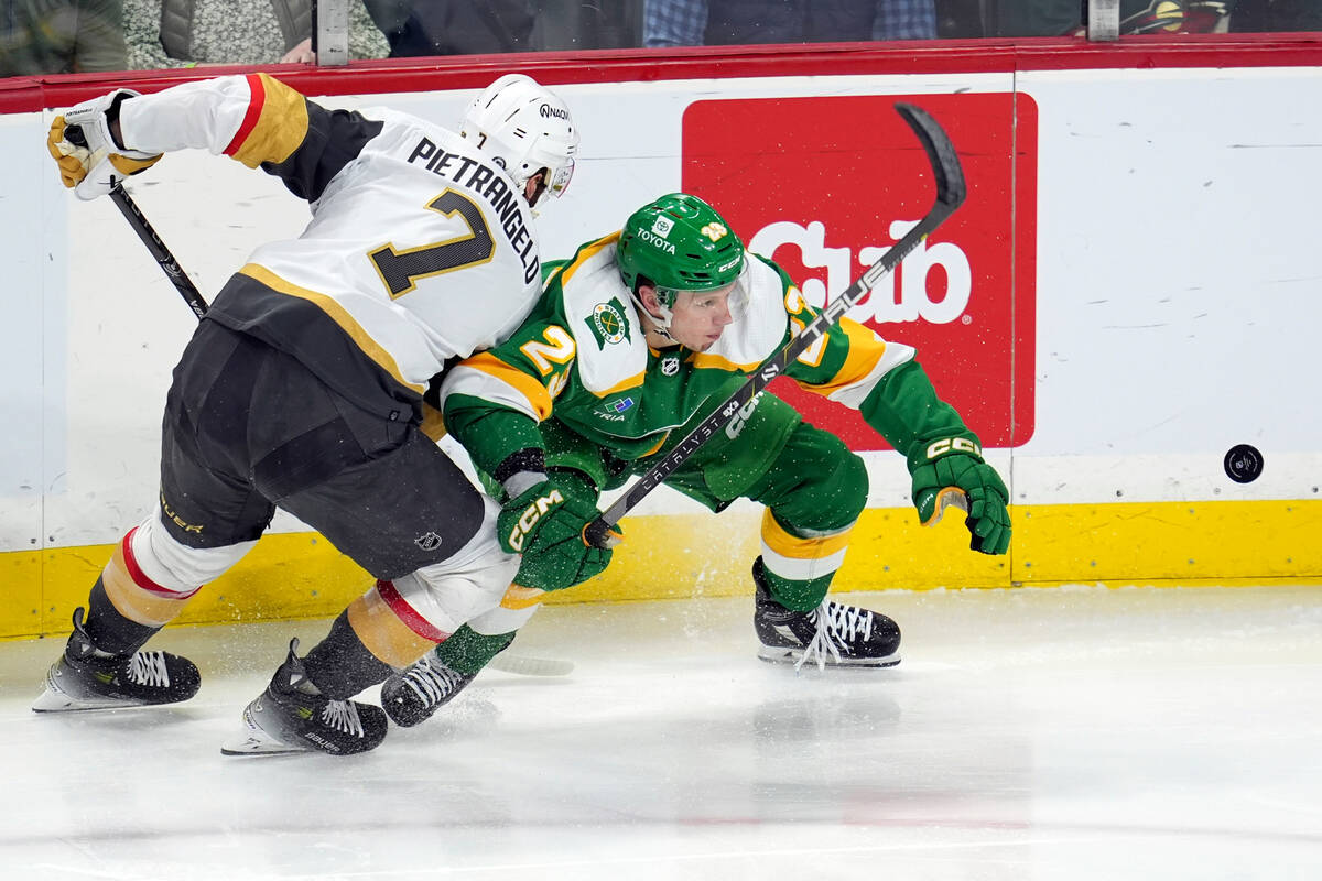 Vegas Golden Knights defenseman Alex Pietrangelo (7) and Minnesota Wild center Marco Rossi batt ...