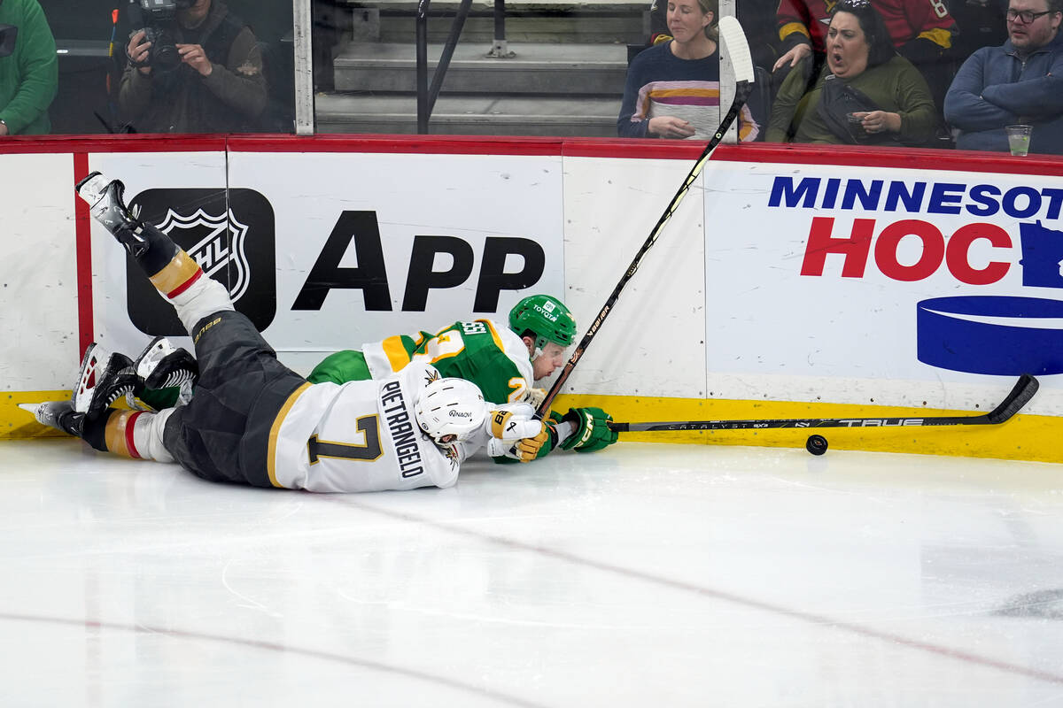 Minnesota Wild center Marco Rossi (23) and Vegas Golden Knights defenseman Alex Pietrangelo (7) ...