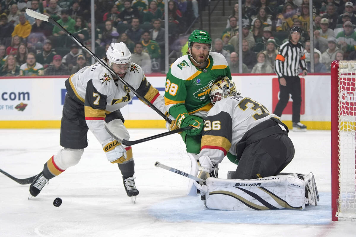 Minnesota Wild right wing Ryan Hartman (38) collides with Vegas Golden Knights goaltender Logan ...