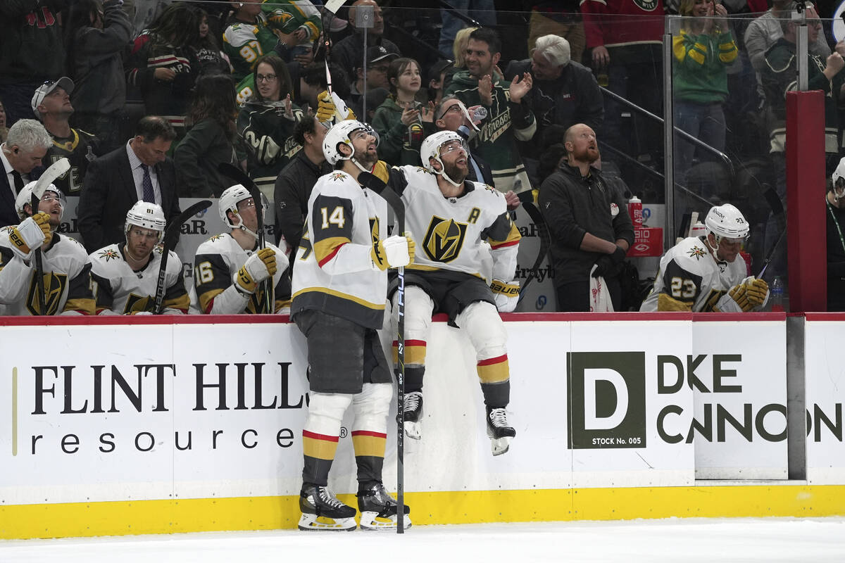 Vegas Golden Knights defensemen Nicolas Hague (14) and Alex Pietrangelo, second right, look at ...