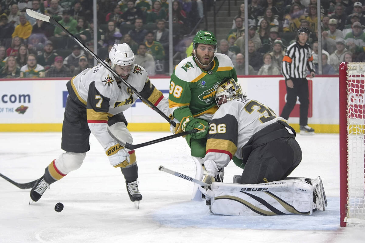 Minnesota Wild right wing Ryan Hartman (38) collides with Vegas Golden Knights goaltender Logan ...