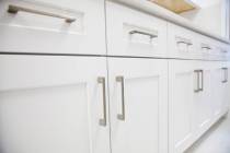 You can dress up your cabinets by installing distinctive knobs or pulls. (Getty Images)