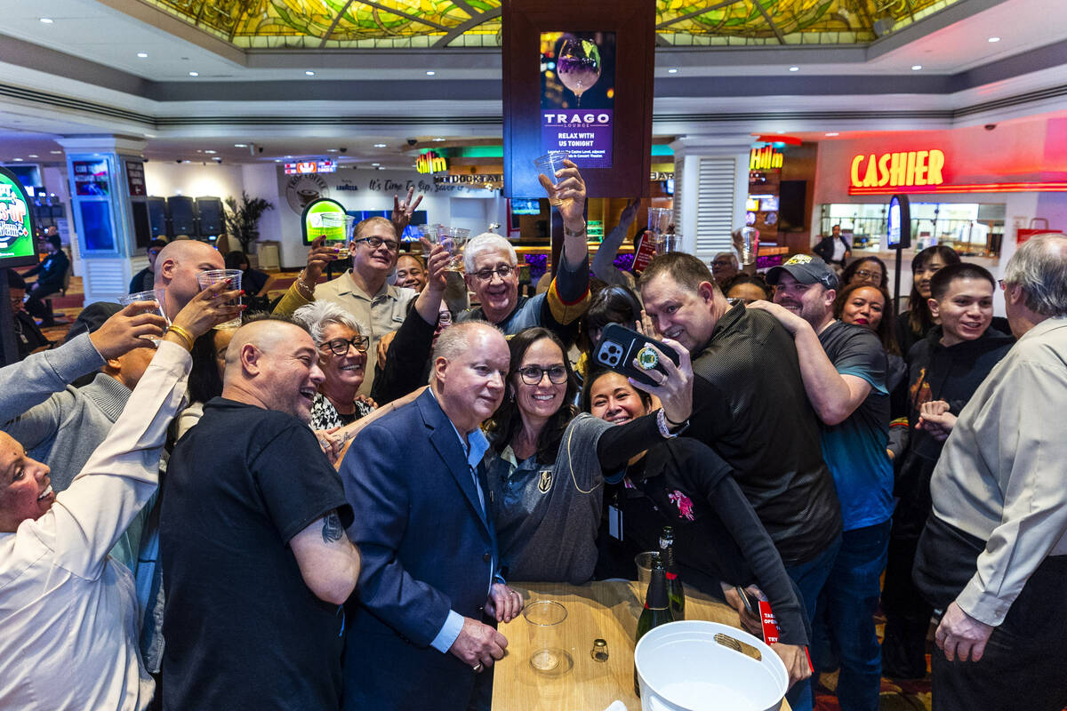 Now shut down, the table games staff and others gather for a 'selfie" and champagne toast ...