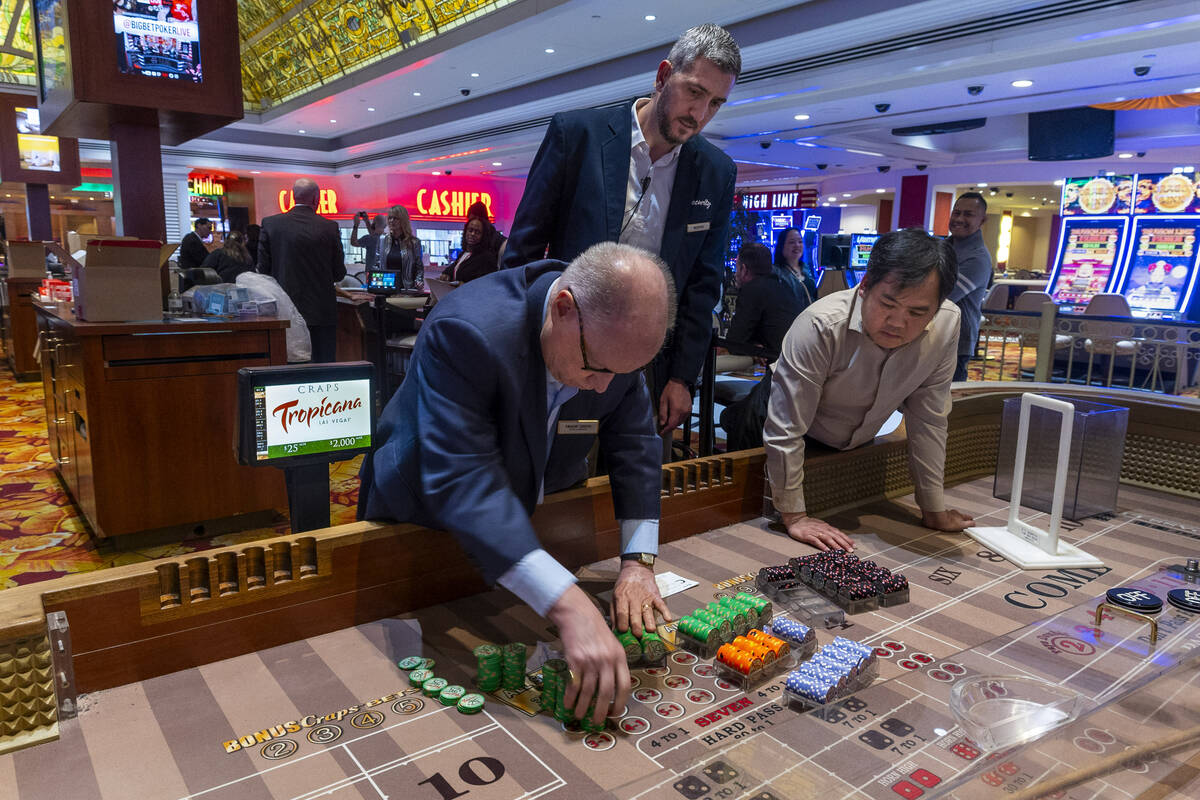 Chips are stacked and counted after the last craps game is concluded during the final night of ...