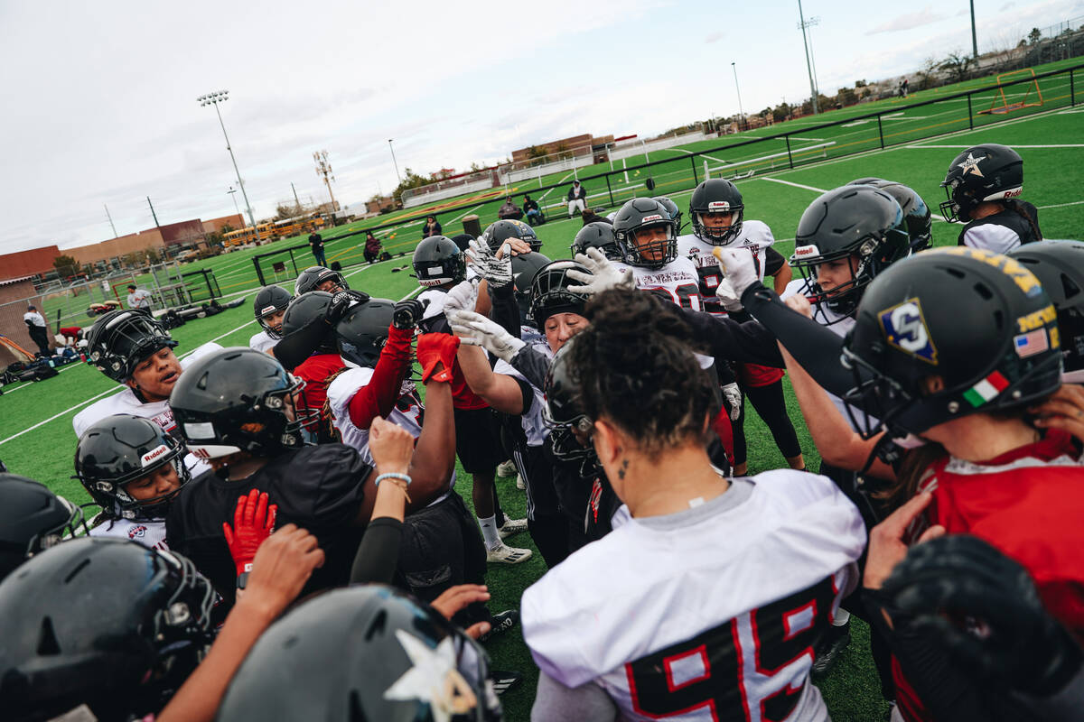 The Las Vegas Silver Stars, a women’s professional football team, huddles together during a p ...
