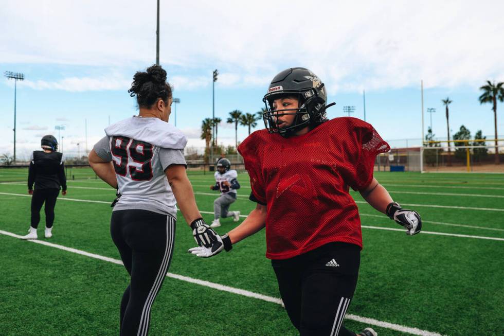 The Las Vegas Silver Stars, a women’s professional football team, practice drills at Fai ...