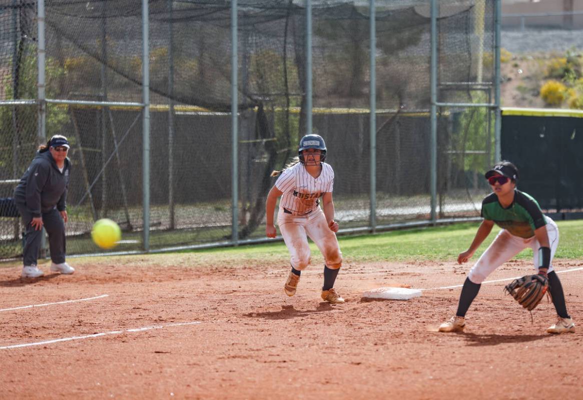 Shadow Ridge High School’s Giselle Castellanos (9) looks to run home past past Palo Verd ...