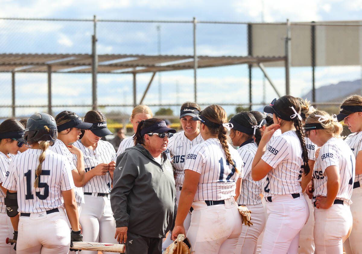 Shadow Ridge High School head coach Julia Meyn talks to her players between innings in a game a ...