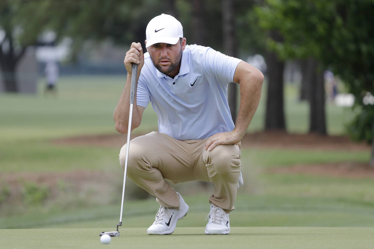 Scottie Scheffler checks the eighth green before his putt during the final round of the Houston ...