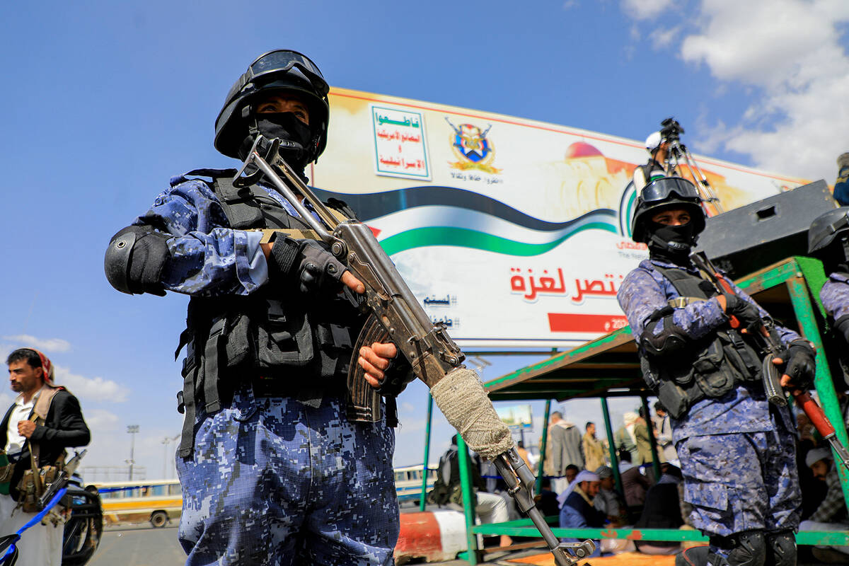 Members of Houthi security forces stand guard during a march in the capital Sanaa on March 15, ...