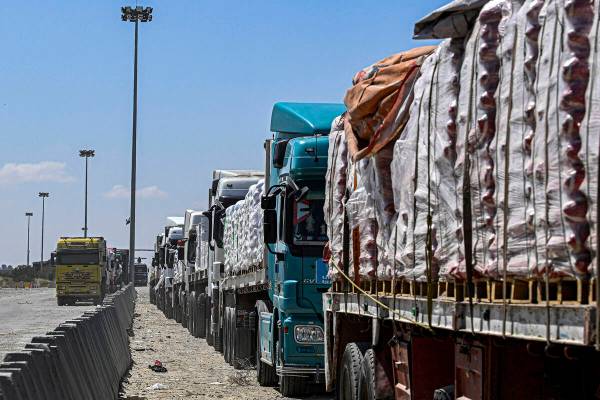 Egyptian trucks carrying humanitarian aid bound for the Gaza Strip queue outside the Rafah bord ...