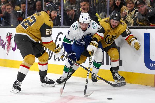 Golden Knights right wing Michael Amadio (22) and center Paul Cotter (43) pressure the puck awa ...