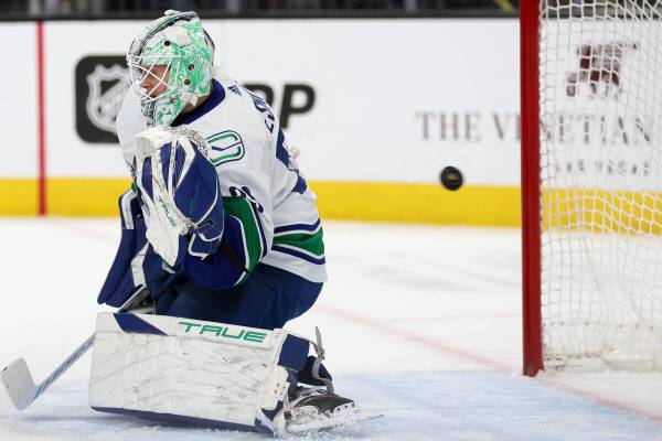 The puck soars past Canucks goaltender Casey DeSmith (29) for a Golden Knights goal during the ...