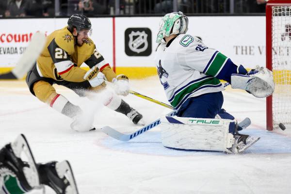 Golden Knights center Brett Howden (21) scores a goal on Canucks goaltender Casey DeSmith (29) ...