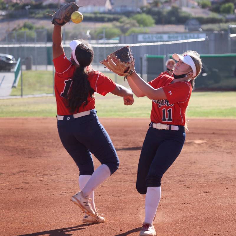 Coronado's Jasmyn Lara (15) and Kendall Selitzky (11) miss a fly ball for a Green Valley single ...