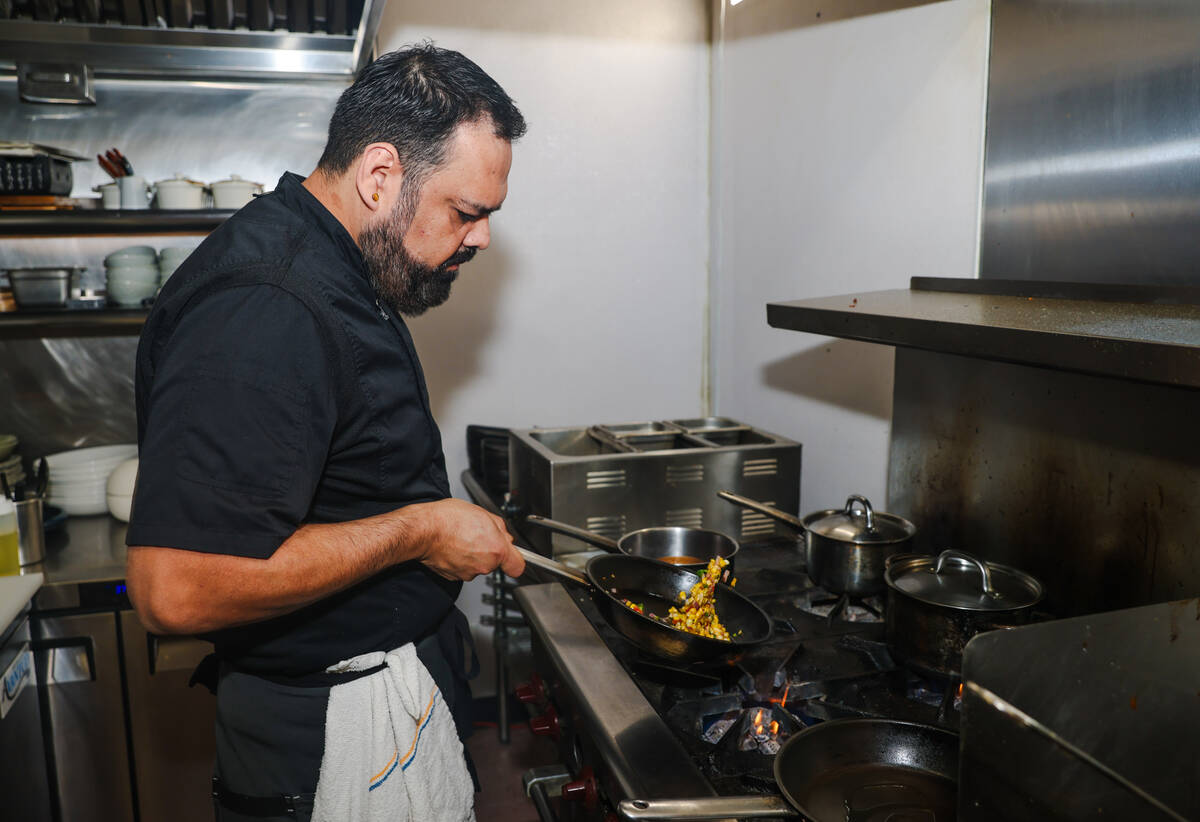 Chef and owner Steve Kestler prepares beef short ribs at his restaurant, Aroma Latin American C ...