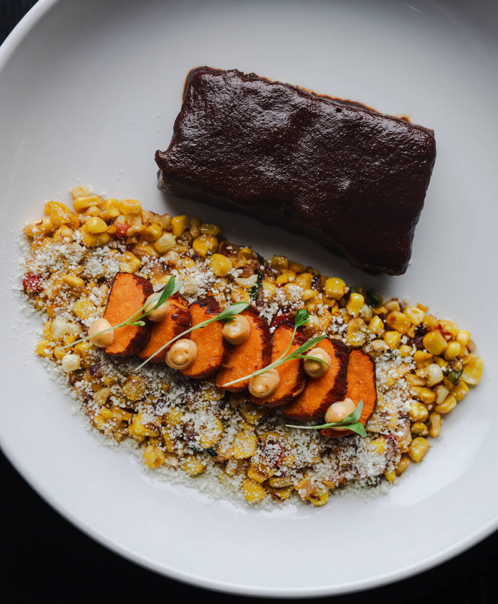 Beef short ribs with mole, roasted sweet potatoes and esquites at Aroma Latin American Cocina, ...