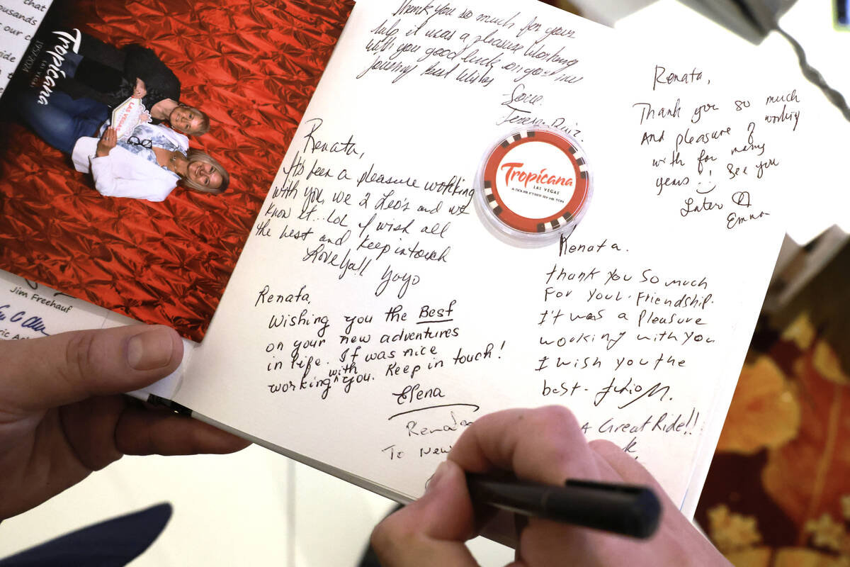 Senior Casino Host Lionel Madrid signs a memory book on closing day at the Tropicana on the Str ...