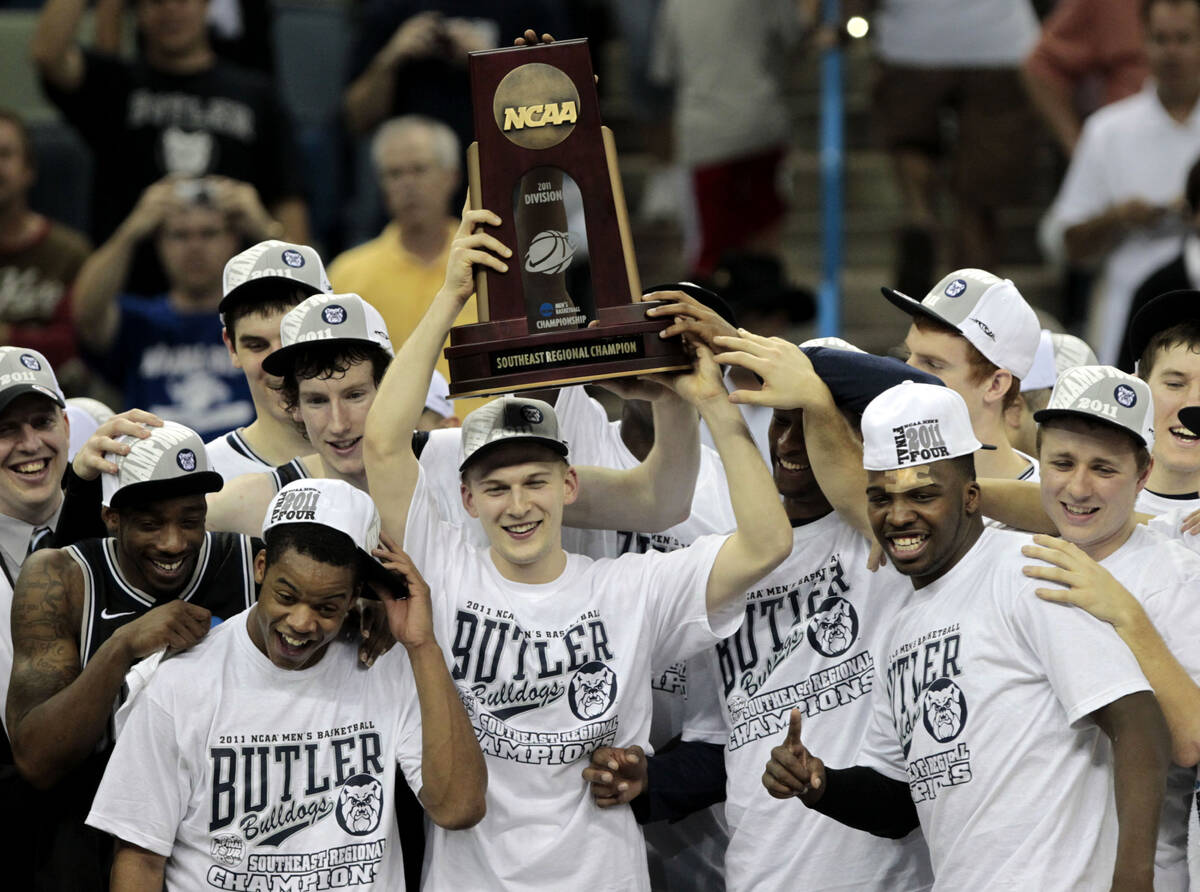 Butler players hold up the Southeast Regional Championship Trophy after their NCAA Southeast re ...
