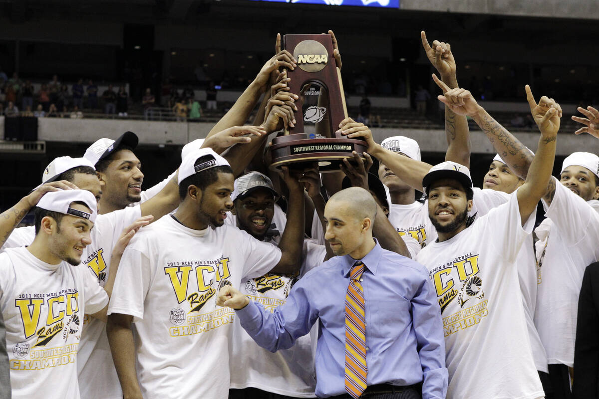 Virginia Commonwealth's team raises the Southwest regional trophy after the finals of the NCAA ...