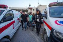 Palestinians carry the body of a World Central Kitchen worker at Al Aqsa hospital in Deir al-Ba ...