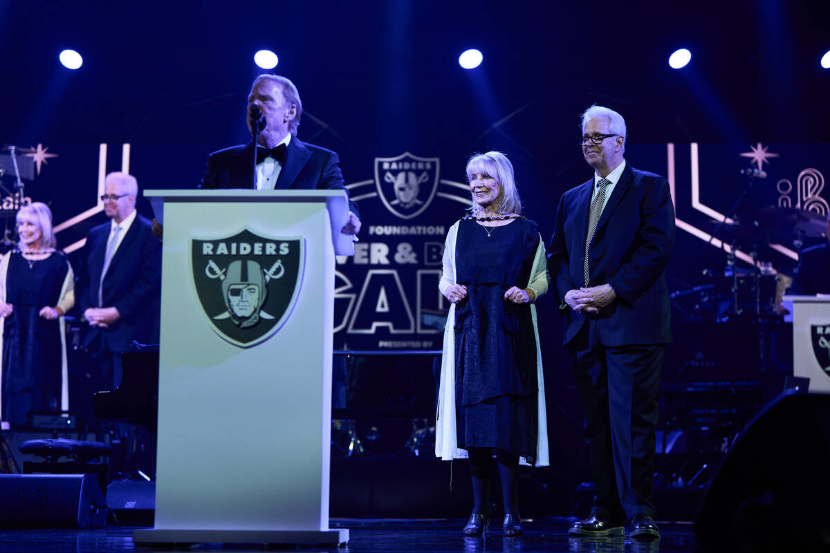 Las Vegas Raiders owner Mark Davis presents the Commitment to Excellence award to Linda Smith a ...