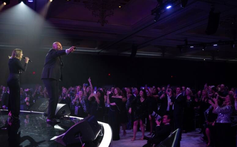 Raiders coach Antonio Pierce, left, and Katharine McPhee duet on "My Girl" at the inaugural Rai ...