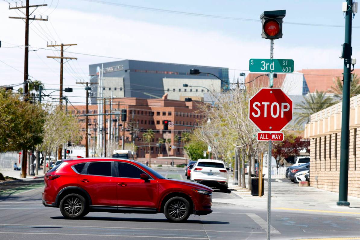 A motorist drives past street signals recently added at the intersections of Third Street and G ...