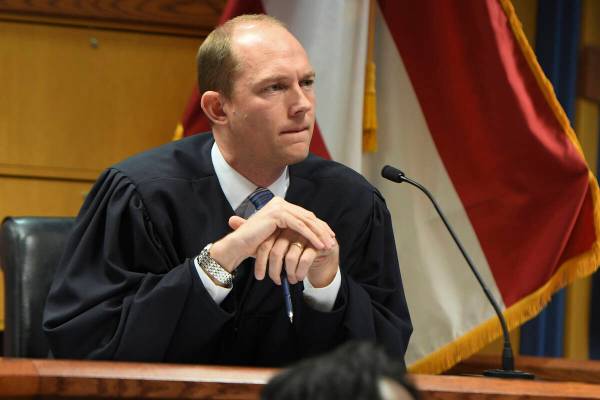 Judge Scott McAfee addresses the lawyers during a hearing on charges against former President D ...