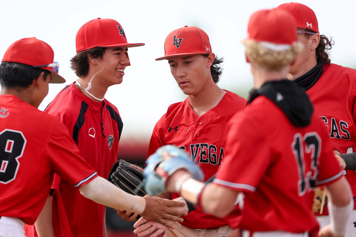 Las Vegas congratulates pitcher Dallas Martinez, center, on a quick inning during a high school ...