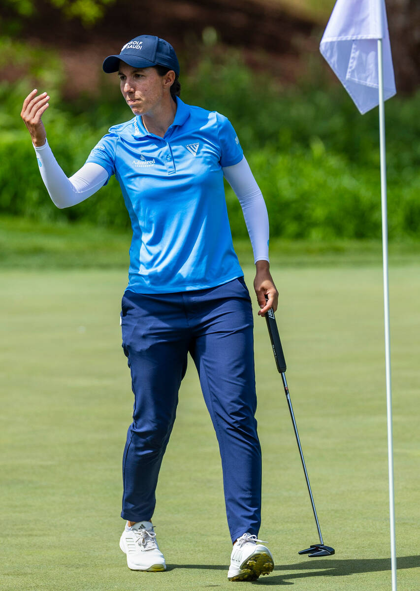 Carlota Ciganda gestures to the fans as they cheer on her latest putt on the 14th hole during t ...
