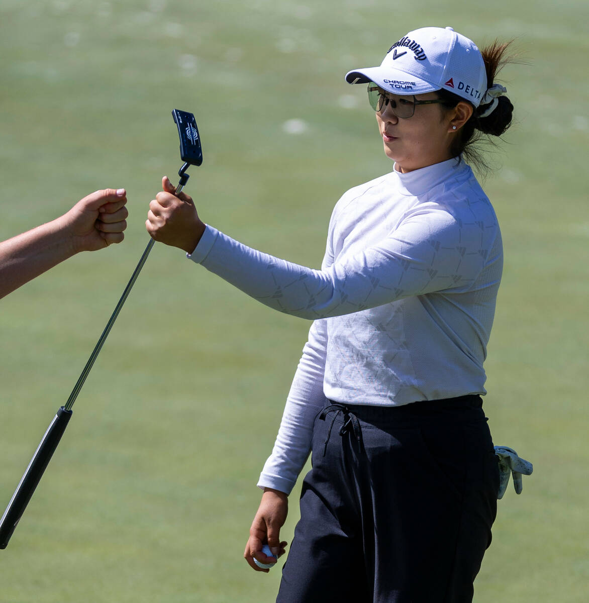 Rose Zhang, gets a fist bump from caddie Brett Olly after another successful putt on hole #7 du ...
