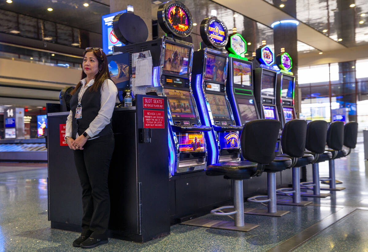 Slots employee Marites Mallari awaits possible players in the baggage area in Terminal 1 at Har ...