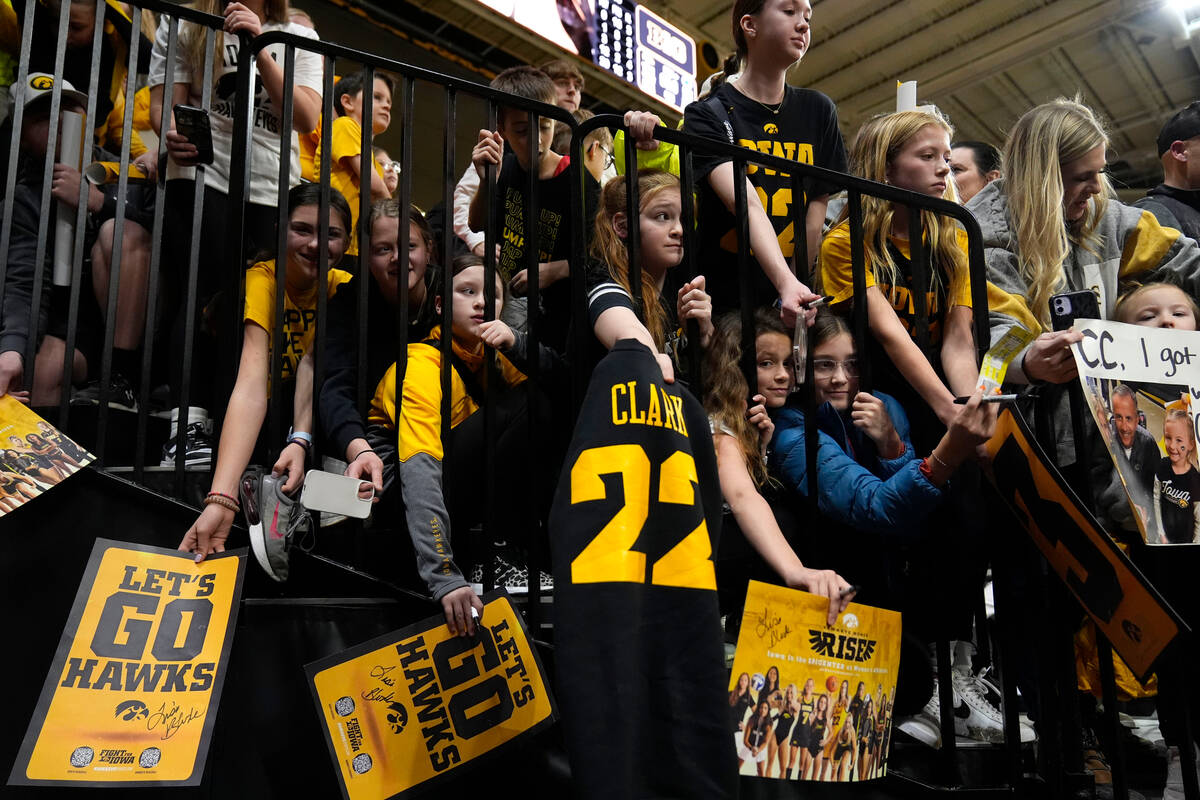 FILE - Fans wait to get an autograph from Iowa guard Caitlin Clark after an NCAA college baske ...