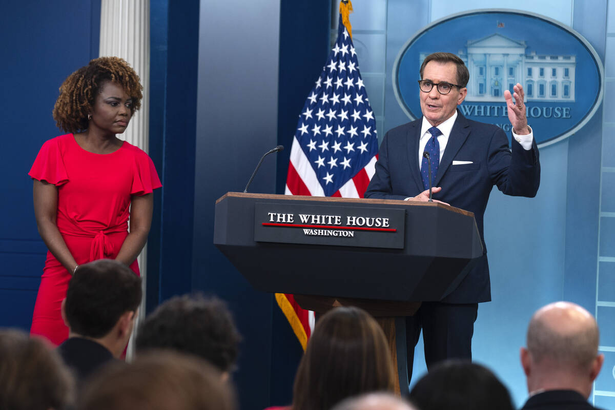 White House press secretary Karine Jean-Pierre listens as White House national security communi ...