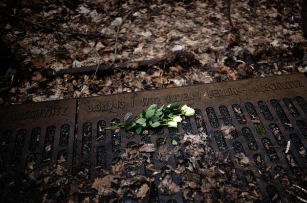 FILE - A white rose is placed at the 'Gleis 17', Track 17, the memorial site for the train tran ...