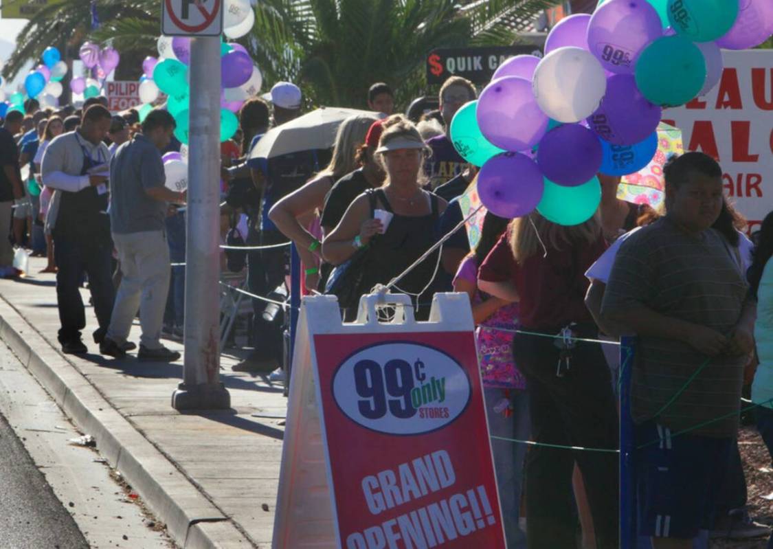 Hundreds of customers line up around the block for the grand opening of the 99 Cents Only store ...