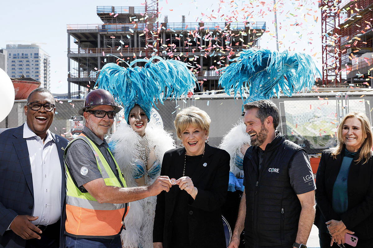 Mayor Carolyn Goodman, center, presents one of her good-luck poker chips to Matt Colman, senior ...