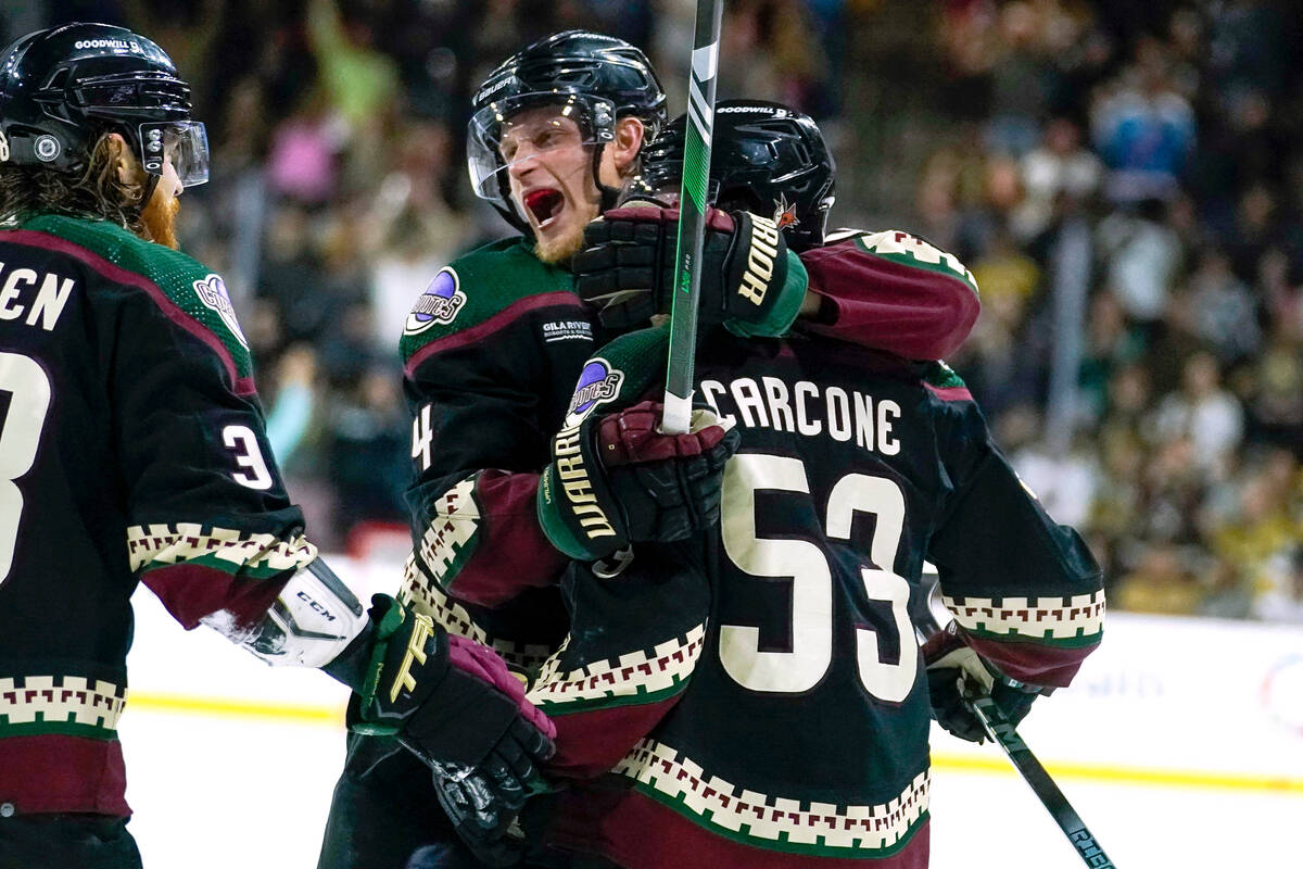 Arizona Coyotes center Nick Bjugstad, middle, celebrates his goal against the Vegas Golden Knig ...